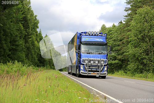 Image of Blue Volvo FH Flower Transport Truck on Summer Road