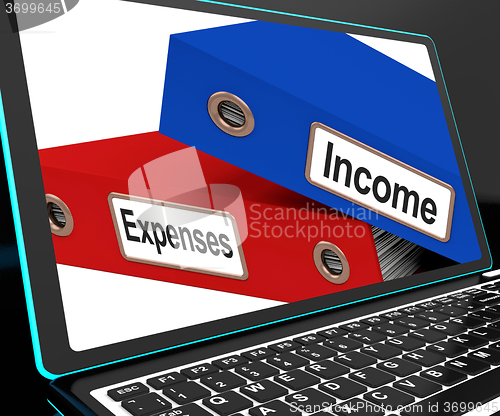 Image of Income And Expenses Files On Laptop Shows Budgeting