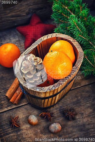 Image of Wooden bucket with tangerines