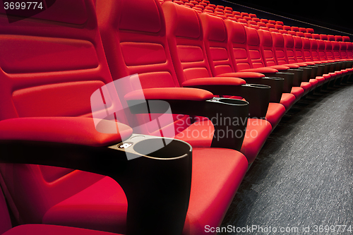 Image of Empty rows of red theater or movie seats