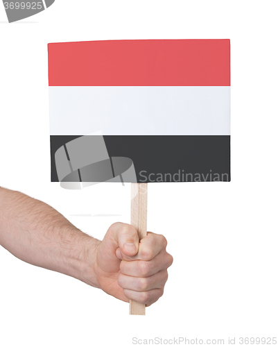 Image of Hand holding small card - Flag of Yemen