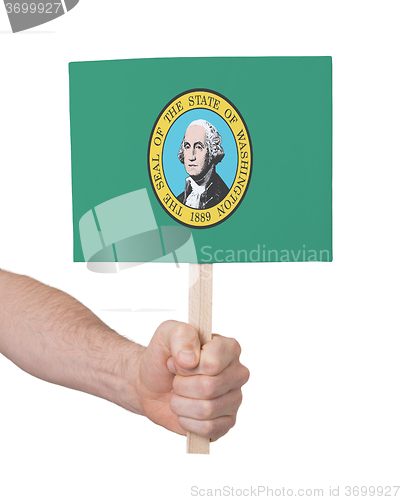 Image of Hand holding small card - Flag of Washington