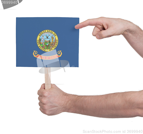 Image of Hand holding small card - Flag of Idaho