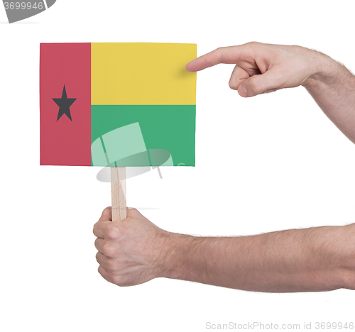 Image of Hand holding small card - Flag of Guinea Bissau