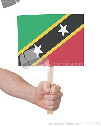 Image of Hand holding small card - Flag of Saint Kitts and Nevis