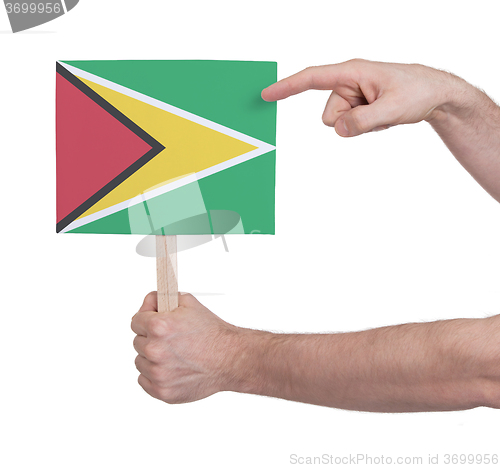 Image of Hand holding small card - Flag of Guyana