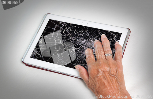 Image of Senior lady with tablet, cracked screen