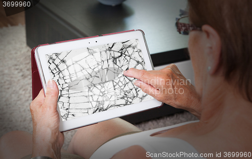 Image of Senior lady with tablet, cracked screen