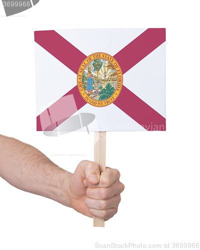 Image of Hand holding small card - Flag of Florida