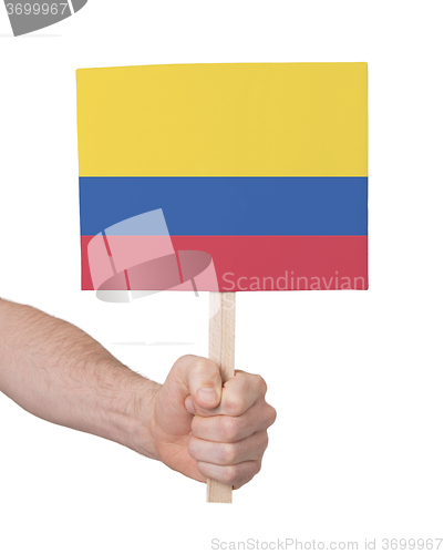 Image of Hand holding small card - Flag of Colombia