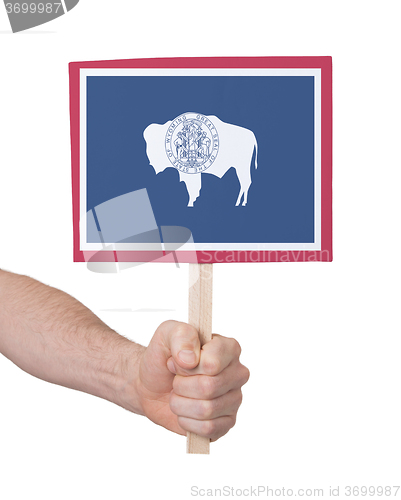 Image of Hand holding small card - Flag of Wyoming
