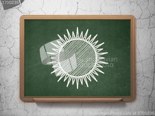 Image of Vacation concept: Sun on chalkboard background