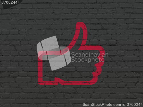 Image of Social network concept: Thumb Up on wall background