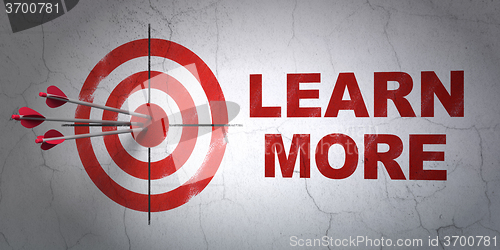 Image of Learning concept: target and Learn More on wall background