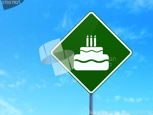 Image of Holiday concept: Cake on road sign background
