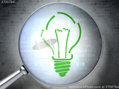 Image of Business concept: Light Bulb with optical glass on digital background