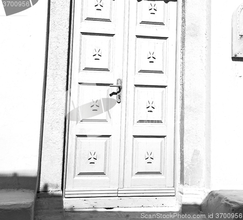 Image of white  red brown  door in antique village santorini greece europ