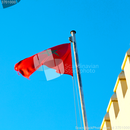 Image of tunisia  waving flag in the blue sky  colour and battlements  wa