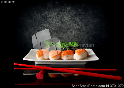 Image of Sushi with chopsticks