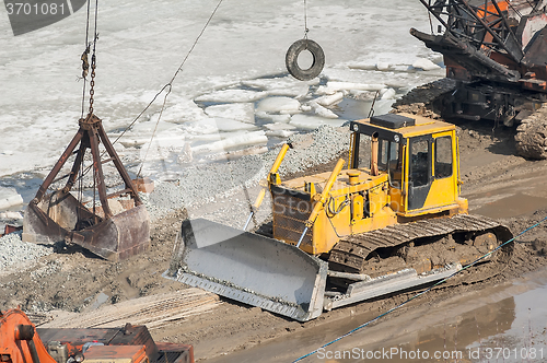 Image of Bulldozer and crane on construction site