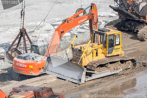 Image of Bulldozer on quay construction site. Tyumen