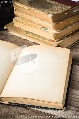 Image of Open old book on a wooden surface 