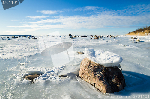 Image of  Stones in the ice on the Sea coast 