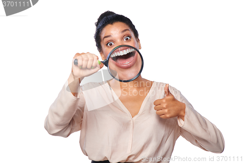 Image of Woman smiling and show teeth through a magnifying glass