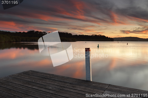 Image of Amazing sunset colours and reflections from the timber jetty