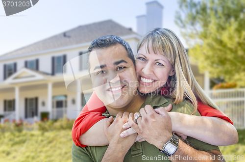 Image of Happy Mixed Race Couple in Front of House