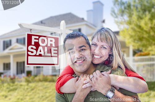 Image of Couple in Front of For Sale Sign and House