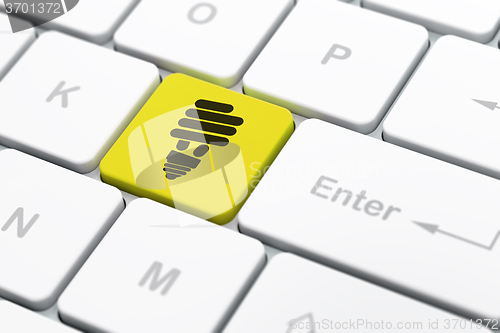 Image of Business concept: Energy Saving Lamp on computer keyboard background