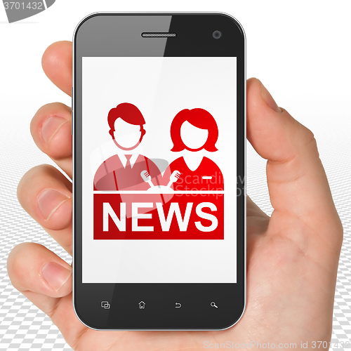 Image of News concept: Hand Holding Smartphone with Anchorman on display