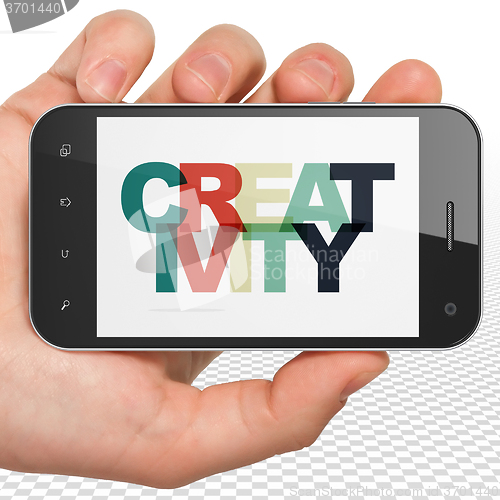 Image of Advertising concept: Hand Holding Smartphone with Creativity on 