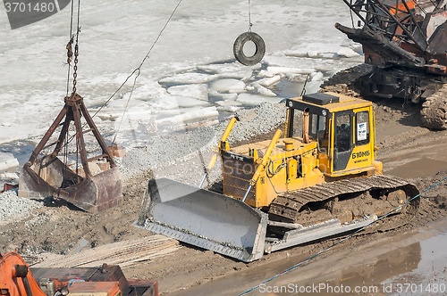Image of Bulldozer on quay construction site. Tyumen