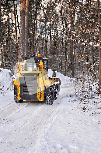 Image of The tractor clears snow from the road