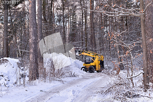 Image of The tractor clears snow from the road