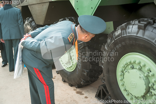 Image of Officer of Kazakh army examine troop-carrier