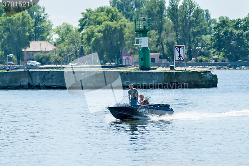 Image of Men go on the boat is Baltiysk. Russia