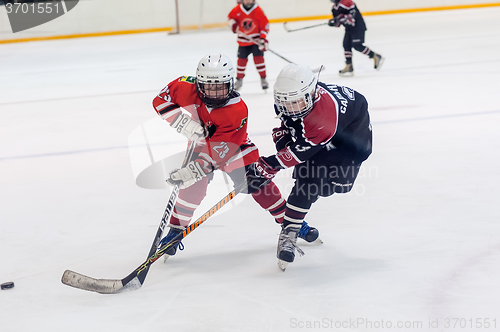 Image of Game moment of children ice-hockey teams