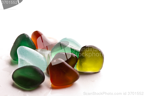 Image of wet glass pieces polished by the sea