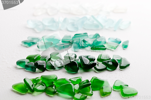 Image of wet glass pieces polished by the sea