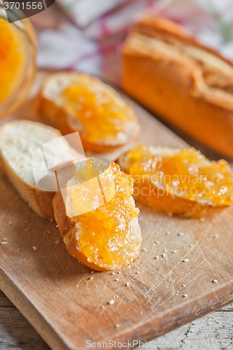 Image of fresh bread with orange jam 