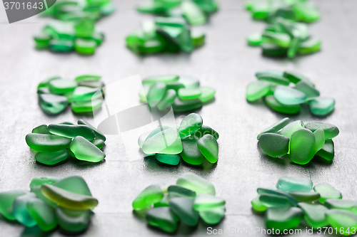 Image of green pieces of glass polished by the sea 