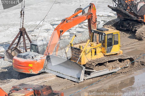 Image of Bulldozer and crane on construction site