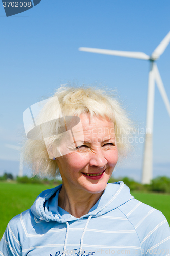 Image of Portrait of a middle-aged woman on the background of wind-driven