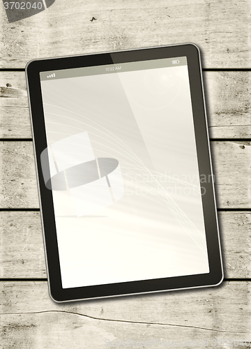 Image of Digital tablet PC on a white wood table