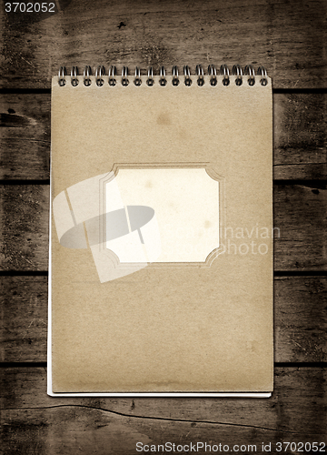 Image of Closed spiral Note book on a dark wood table