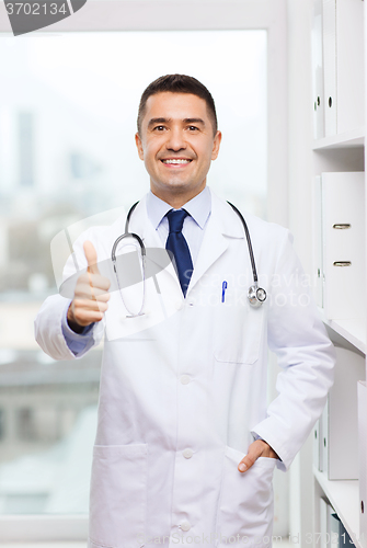 Image of smiling doctor in white coat at medical office