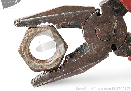 Image of Closeup of old pliers and nut
